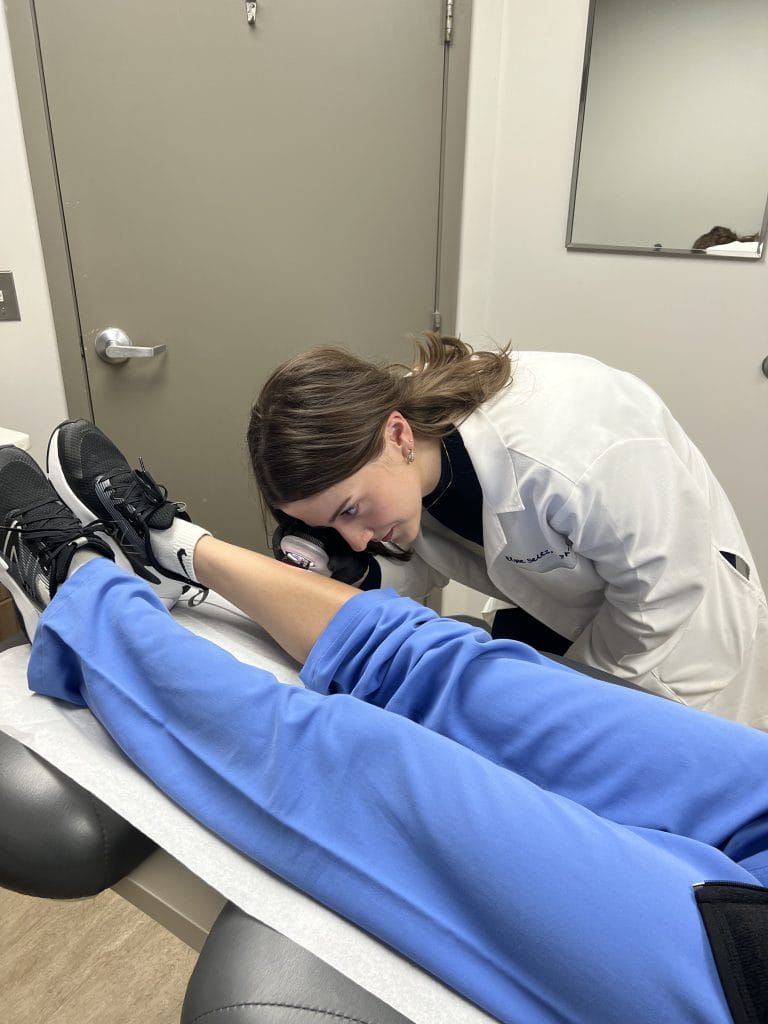 doctor inspecting legs